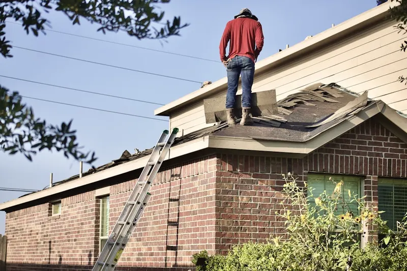 Professional roofer working on a residential roof in Tahoma